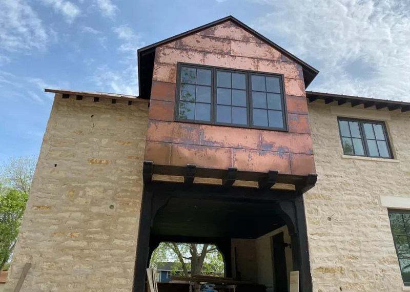 Copper metal panel facade on a stone building for Skylight Installation in Macclenny